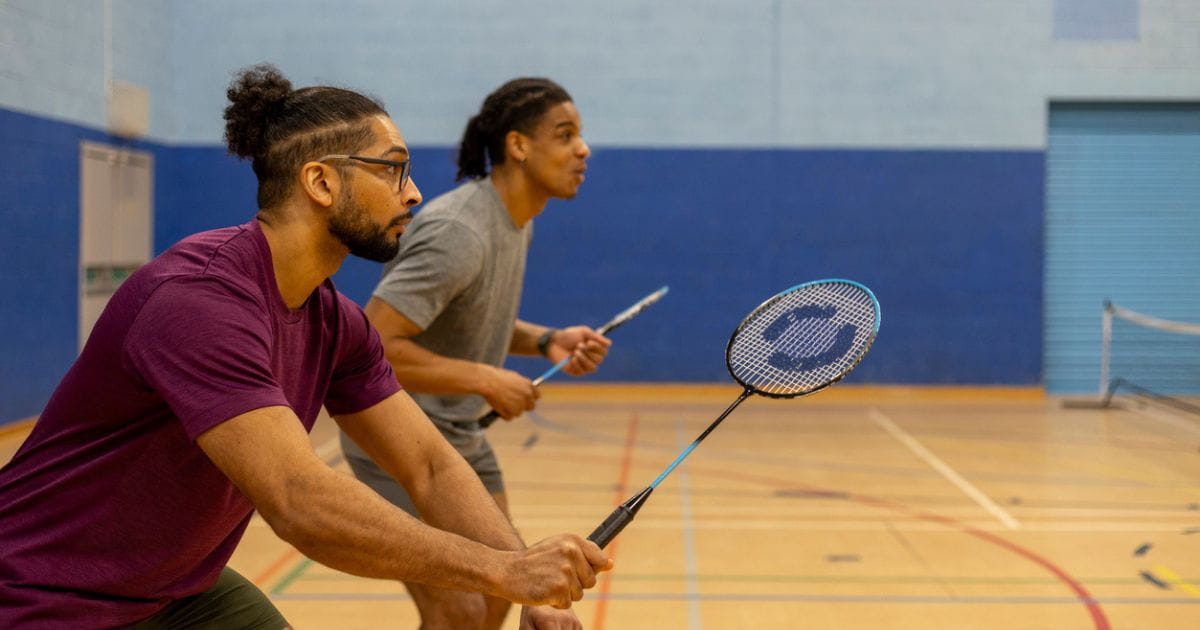 A stock image of two men playing badminton