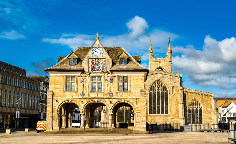 a church with a clock tower in front of a building