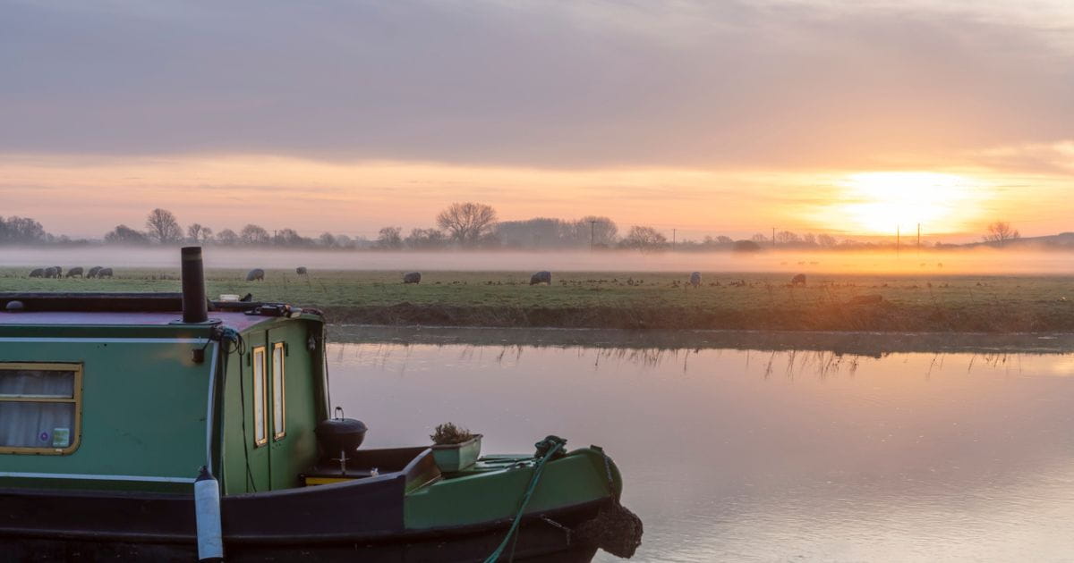 The River Great Ouse in Cambridgeshire with a narrow boat in the foreground