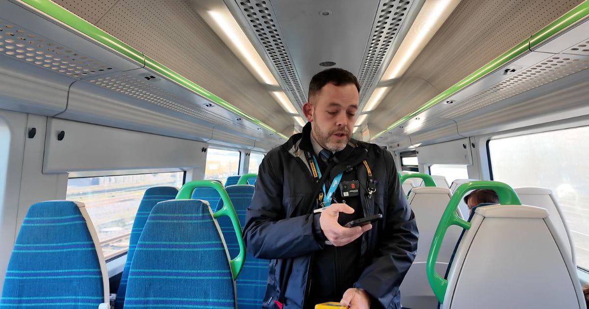 Great Northern passenger host checking tickets