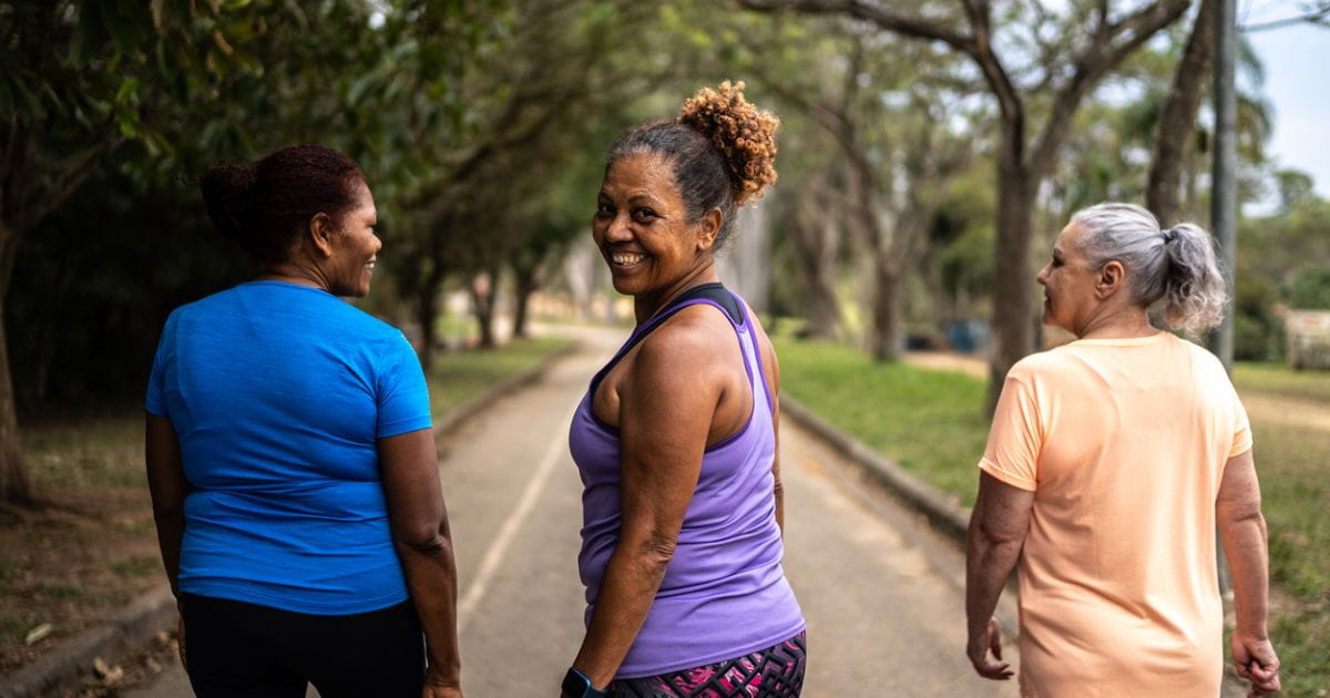 A stock image of three happy women walking outdoors
