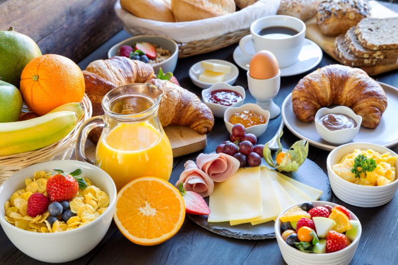 a bowl of fruit sitting on top of a table full of food