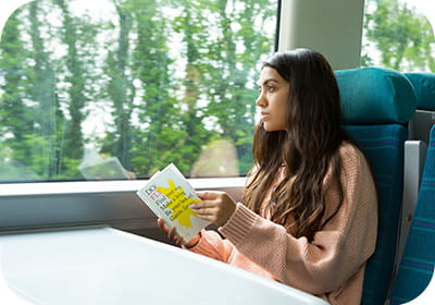 Person sitting on a train reading a book
