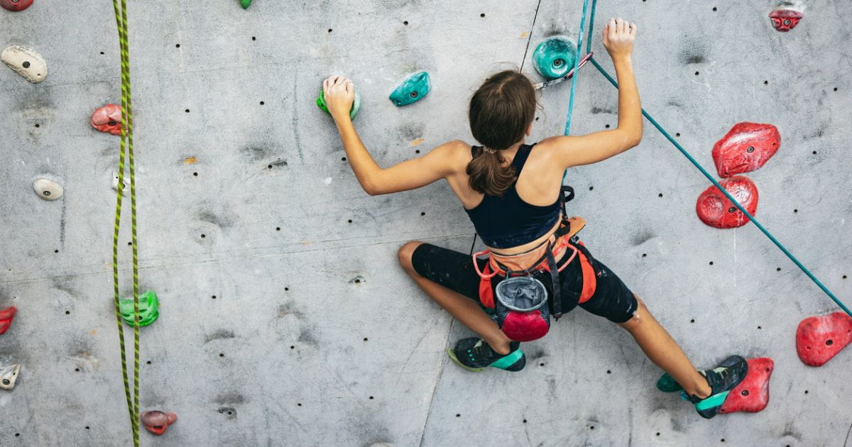 A woman doing indoor climbing